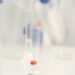 Vaccination research laboratory with scientists studying vaccine data and responses.