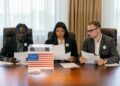 A group of officials discussing cryptocurrency regulations at a conference table.