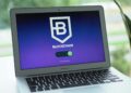 Pilot project showcasing blockchain technology for digital government bonds on a laptop screen.