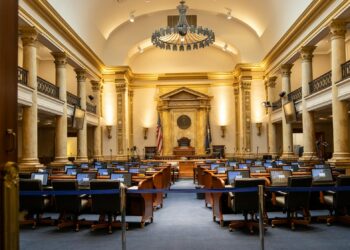 Congress members debating in chamber, emphasizing foreign policy and military presence.