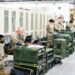 Military personnel examining a Bitcoin node setup in a secure facility.