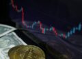 Judge's gavel with cryptocurrency symbols and financial charts in the background.