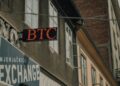 A courthouse with a cryptocurrency exchange logo, symbolizing legal battles in finance.