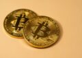 SBI Holdings executives discuss Bitbank acquisition amidst cryptocurrency market changes.