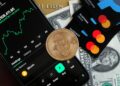 A user holding a credit card with cryptocurrency icons against a digital finance backdrop.