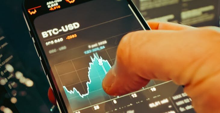 A man checks cryptocurrency prices on a smartphone amidst financial news articles.