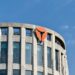 A Bithumb office building with cryptocurrency logos, reflecting recent legal changes.