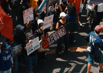 People rallying with signs advocating for cryptocurrency regulation reforms.