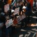 People rallying with signs advocating for cryptocurrency regulation reforms.