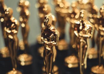 Red carpet at Oscars with film industry professionals discussing AI content regulations.