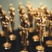 Red carpet at Oscars with film industry professionals discussing AI content regulations.