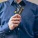 A person holding a debit card labeled "MoonAgents" with cryptocurrency symbols in the background.
