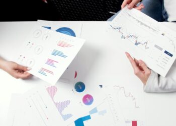 Senators discussing regulations at a roundtable, with charts and graphs related to prediction markets.