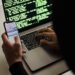 Laptop with cryptocurrency symbols and hacking code on the screen, highlighting cyber theft.