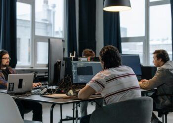 Developers collaborating on Ethereum applications at a tech workspace.