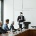 A group of bank representatives discuss stablecoin regulations in a conference room.