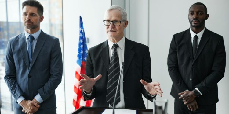 Jerome Powell speaking at a podium during a Federal Reserve meeting.