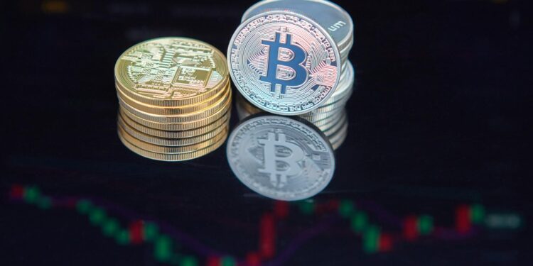 Bitcoin coins stacked with a backdrop of digital graphs and mining equipment.