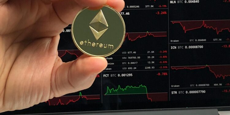 Crypto whales monitoring Ethereum trends on digital devices with financial graphs displayed.