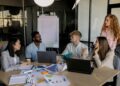 A group of diverse professionals discusses regulations on prediction markets in a conference room.