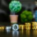 Stacks of cryptocurrency coins with US Treasury emblem in the background.