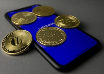 A digital graphic featuring the Coinbase logo alongside symbols of blockchain and finance.